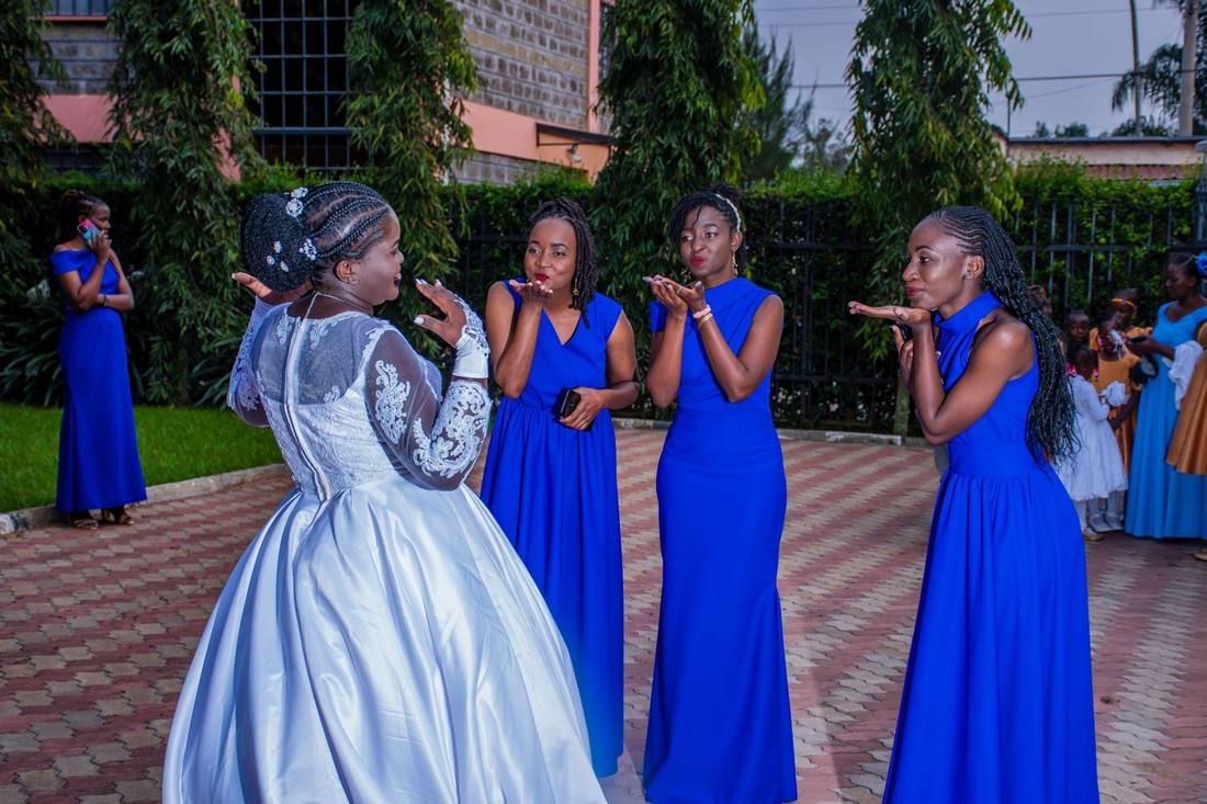 Bride with bridesmaids blowing kisses