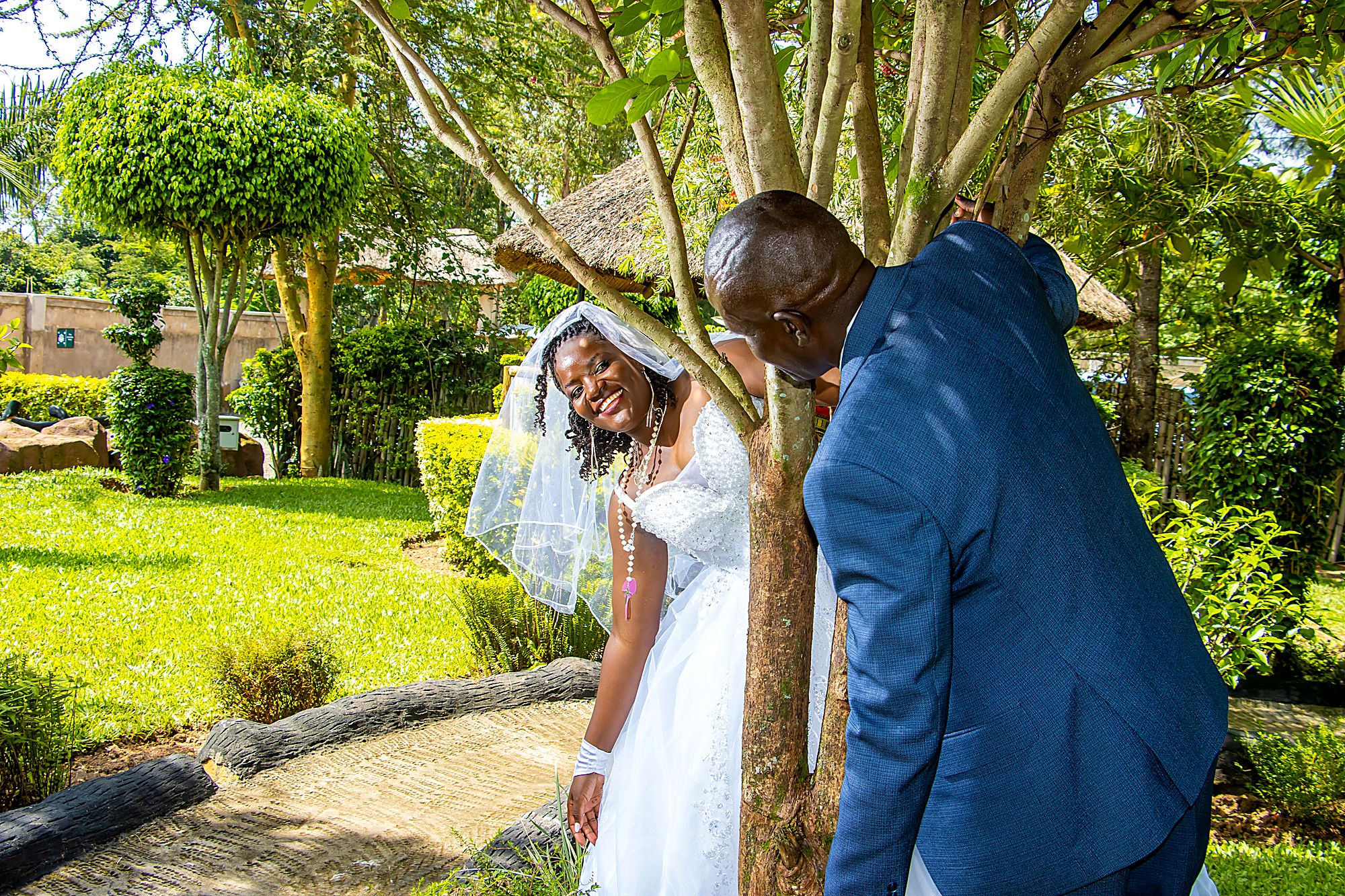 Bride and groom sharing a candid laugh in a garden