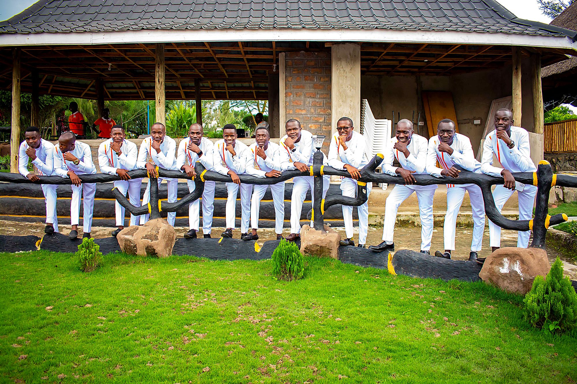 Groomsmen in matching white suits posing together